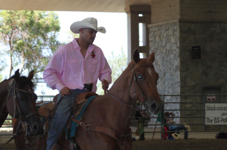 Reuben Haynes, 35, a resident of Los Angeles rides in the main arena just before he competes in the bull doggin' event.