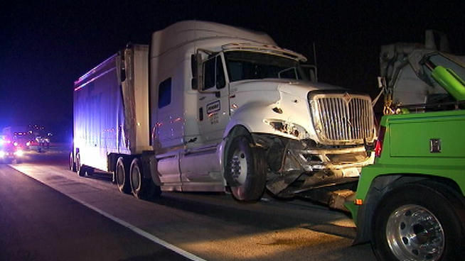 A big rig is towed from the scene of a fatal crash on the westbound 60 Freeway. Traffic is backed up for miles.