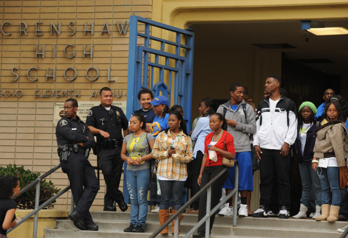 Students and police watch teachers, pare