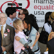 Same-sex couples kiss at a recommitment