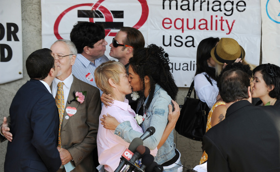 Same-sex couples kiss at a recommitment