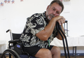 Metrolink commuter rail collision survivor Raymond Conklin, who was in the first car of the commuter train that was crushed by a freight train in 2008 in Los Angeles resulting in eight surgeries and faces over one million dollars in medical bills, attends a meeting with U.S. Rep. Elton Gallegly, not seen, Tuesday, Aug. 31,2010, in Simi Valley, Calif. Gallegly and accident survivors discussed ways to lift the liability limits established by the railroad and former contractor, Connex Railroad, last week. Metrolink and Connex agreed to set up a $200 million fund for victims. Victims say the sum isn't enough to cover their losses and medical expenses.