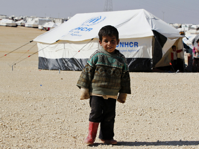 A Syrian refugee boy stands outside his tent at Al Zaatri refugee camp in the Jordanian city of Mafraq, near the border with Syria, earlier this week.