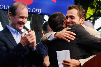 Plaintiffs Paul Katami (L) hugs his partner Jeff Zarrillo as their lawyer David Boies (R) looks on during a rally to celebrate the ruling to overturn Proposition 8 on August 4, 2010 in West Hollywood, California.