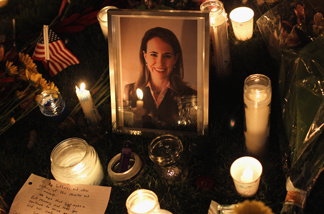 Candles surround a portrait of U.S. Rep. Gabrielle Giffords (D-AZ), who was shot January 8, 2011 in Tuscon, Arizona. Giffords was shot in the head at a public event entitled 'Congress on Your Corner' when a gunman opened fire outside a Safeway grocery store in Tucson. It was reported that eighteen people were shot, including members of Giffords' staff, and six are dead, including one young child. One suspect is in custody.