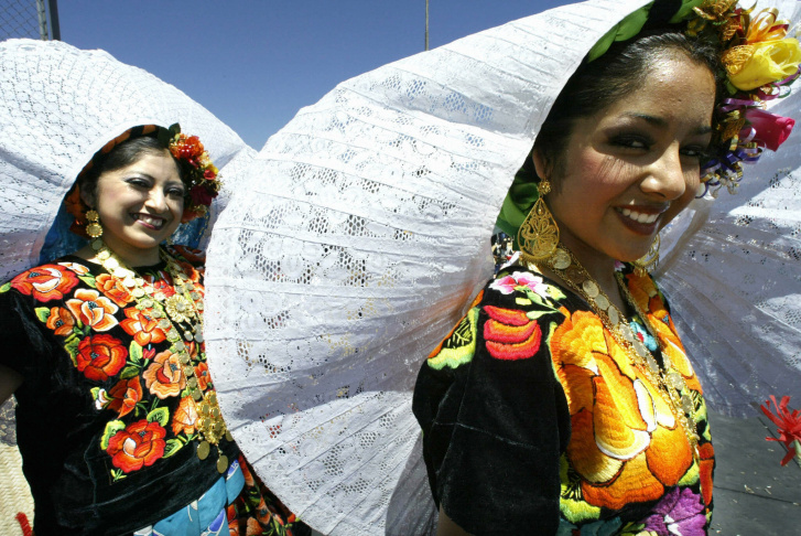 Two girls wearing Oaxacan traditional co