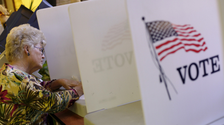 A voter fills out her ballot during early voting before the 2012 presidential election at the Gila County Recorder's Office in Globe, Ariz., on Oct. 26.