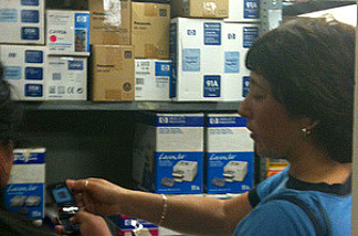Teachers consult notes about needs, and call schools to check printer cartridge numbers. Printer cartridges are high-demand items for groups with tight budgets.