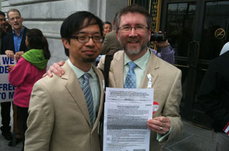 Couple Jeff Tabaco and Thom Watson stand on the steps outside San Francisco County Clerk's Office for a marriage license, with their application already filled out