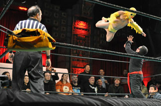 Li'l Chicken leaps onto his opponent.