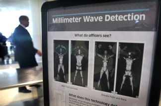 A sign informs travelers about Millimeter Wave Detection technology used in full body scanners at Midway Airport in Chicago, Illinois.
