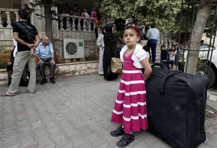 Syrian refugees wait in Beirut before a flight to Germany on Wednesday. More than 100 Syrians were on the flight, the first mass relocation program for Syrian refugees. Germany has agreed to take in 5,000 of them.