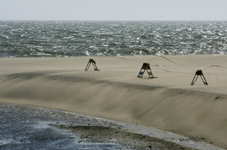 A file photo of barriers warning people to stay away from a drainage that carries dangerous levels of bacteria into the ocean south of Will Rogers State Beach, north of Santa Monica, California.