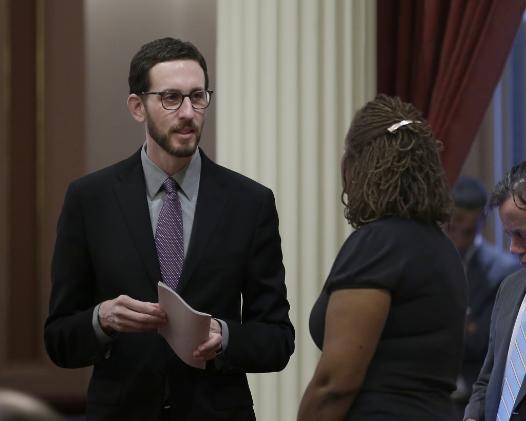 State Sen. Scott Wiener, D-San Francisco, left, talks with Sen. Holly Mitchell, D-Los Angeles, at the Capitol, Thursday, Jan. 26, 2017, in Sacramento, Calif.