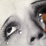 A visitor looks at the photo "Tears" by