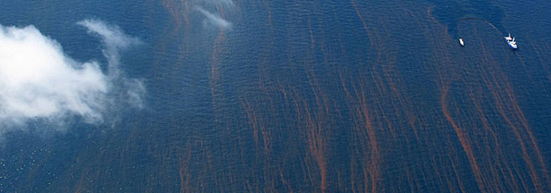 The Gulf's blue waters are streaked with reddish tendrils of oil.