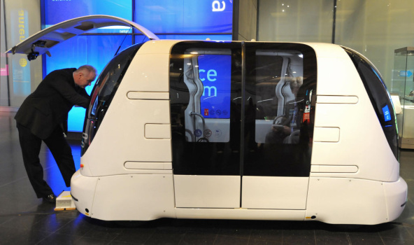 An engineer adjusts a driverless car dur