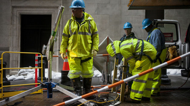 Consolidated Edison workers try to repair damage near the New York Stock Exchange on Tuesday.