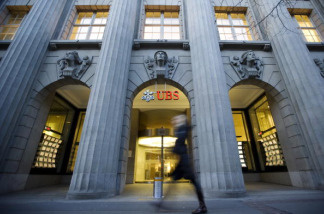 This picture shows a person walking past a building of the Swiss Bank UBS in the Bahnhofstrasse in Zurich