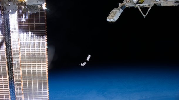 A set of NanoRacks CubeSats is photographed by an Expedition 38 crew member after deployment by the NanoRacks Launcher attached to the end of the Japanese robotic arm. The CubeSats program contains a variety of experiments such as Earth observations and advanced electronics testing. International Space Station solar array panels are at left. Earth's horizon and the blackness of space provide the backdrop for the scene.
