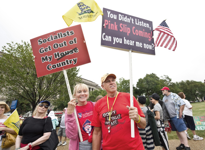Demonstrators hold signs near the Washin