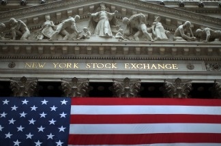 U.S. stocks closed lower on Christmas Eve, as investors worried about the fiscal cliff. Meanwhile, retailers report stronger sales before the holiday, though one tracking group said shoppers were spending less than in 2011.