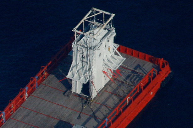 The Joe Griffin barge carrying the containment box, which will be used to try to contain the Deepwater Horizon oil spill, sits surrounded by oil on May 6, 2010 in the Gulf of Mexico. The Deepwater Horizon oil rig operated by BP is leaking an estimated 5,000 barrels of oil a day into the Gulf.