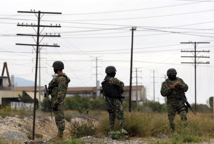 Three members of the Mexican Army watch