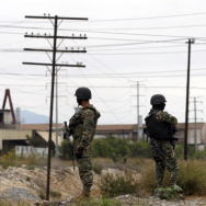 Three members of the Mexican Army watch