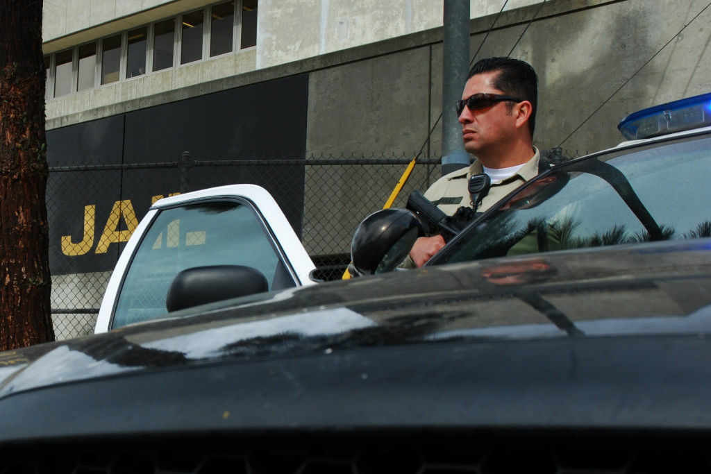 Sheriff's Deputy Rodriguez, an officer from the Los Angeles County Sheriff's Department, guards an intersection outside the Twin Towers Correctional Facility in Los Angeles on Feb. 8, 2013.