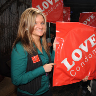 AIDS activists carry large condom packet