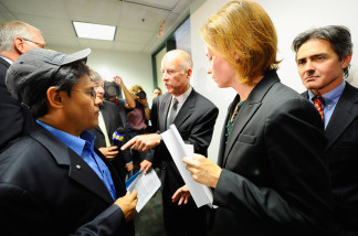 California Attorney General Jerry Brown (C) asks his deputy Susan Leach (2nd R) to speak with a city of Bell resident Nestor Valencia (2nd L) after a news conference where he announced his office has issued subpoenas on July 26, 2010 in Los Angeles, California.