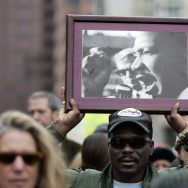 A man holds a portait of Martin Luther K