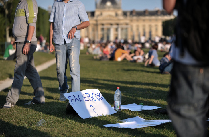 A paper sheet shows the word "facebook"