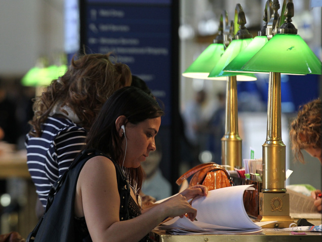A customer goes over tax documents at a post office in New York City on last year's Tax Day.