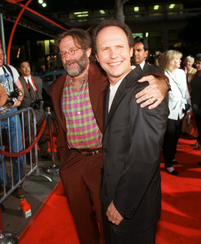 Actors Robin Williams, left, and Billy Crystal, right, joke around for photographers as they arrive at Mann's Chinese Theatre in the Hollywood area of Los Angeles for the premiere of "Father's Day" Tuesday, May 6, 1997. (AP Photo/Susan Sterner)