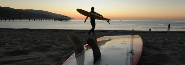 A surfer enters the water before tribal elder Mati Waiya from the Chumash Nation conducts the dedication ceremony for the iconic Malibu Surfrider Beach to become the first 'World Surfing Reserve' (WSR), in Malibu on October 9, 2010.