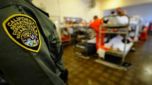 A California Department of Corrections officer speaks to inmates at Chino State Prison