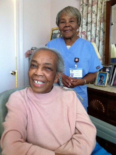 Onether Lowery, 80, (standing) is a home health aide for Rosalie Lewis, 86. As a whole, the aides are largely female and far older than women in the general workforce.