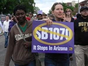 A protester holds a union anti-SB 1070 sign, May 1, 2010