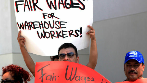 Warehouse workers rally in Riverside after announcing a class action lawsuit against a Wal-Mart warehouse operated by Schneider Logistics.