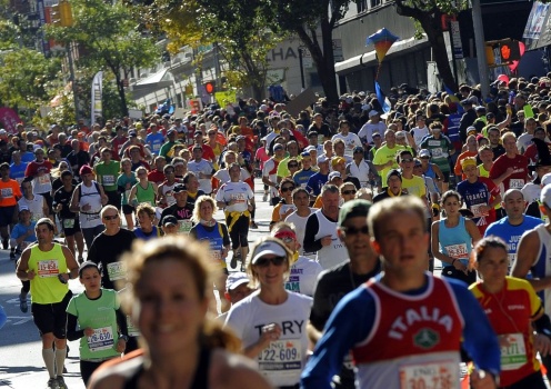 Runners make their way up 1st Avenue in
