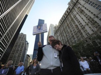 A couple holds a sign with a photo of James Patrick White, who died in the Sept. 11 terrorist attacks, during a memorial service commemorating the ninth anniversary of the Sept. 11 terrorist attacks on the World Trade Center Saturday, Sept. 11, 2010 in New York.