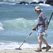 A man uses a metal detector while search