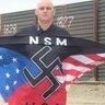 National Socialist Movement's Jeff Hall with NSM flag.