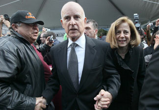 California governor Jerry Brown (C) makes his way through a crowd with his wife Anne Gust Brown (R) during the People's Party after he was sworn in as the 39th governor of California by California on January 3, 2011 in Sacramento, California.