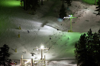 Skiers take advantage of well-lit slopes through the night at Mountain High ski resort, January 24, 2001 near Wrightwood, CA.