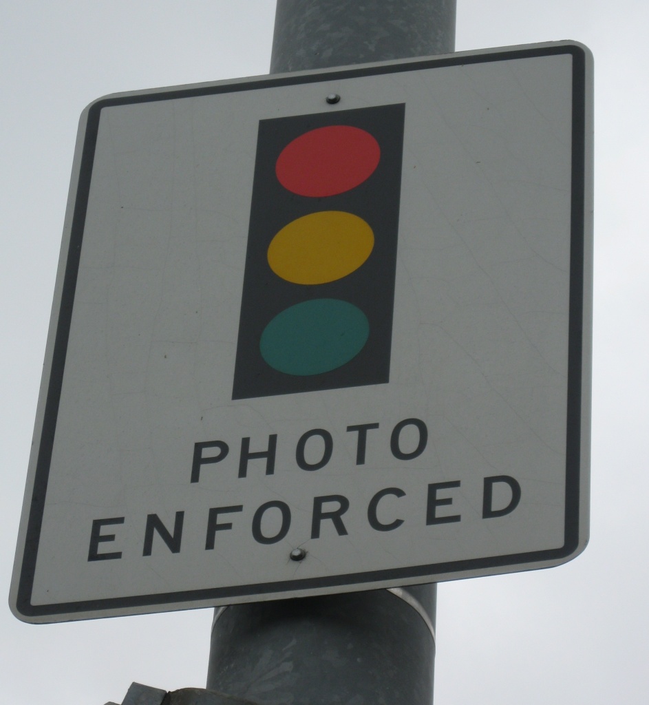 Signs such as this one in Laguna Beach warn drivers about red-light cameras in the city.