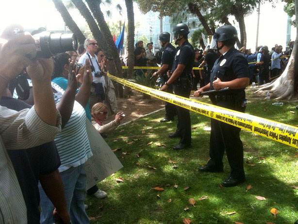 Police in riot gear formed a line in front of a crowd of about 500 people gathered south of City Hall today to protest a white supremacist rally. One person was beat by counterprotesters as of Saturday afternoon.