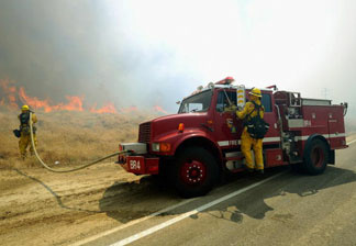 Cal Fire firefighters battle the Crown Fire on July 30, 2010 in the hills above Palmdale, California.